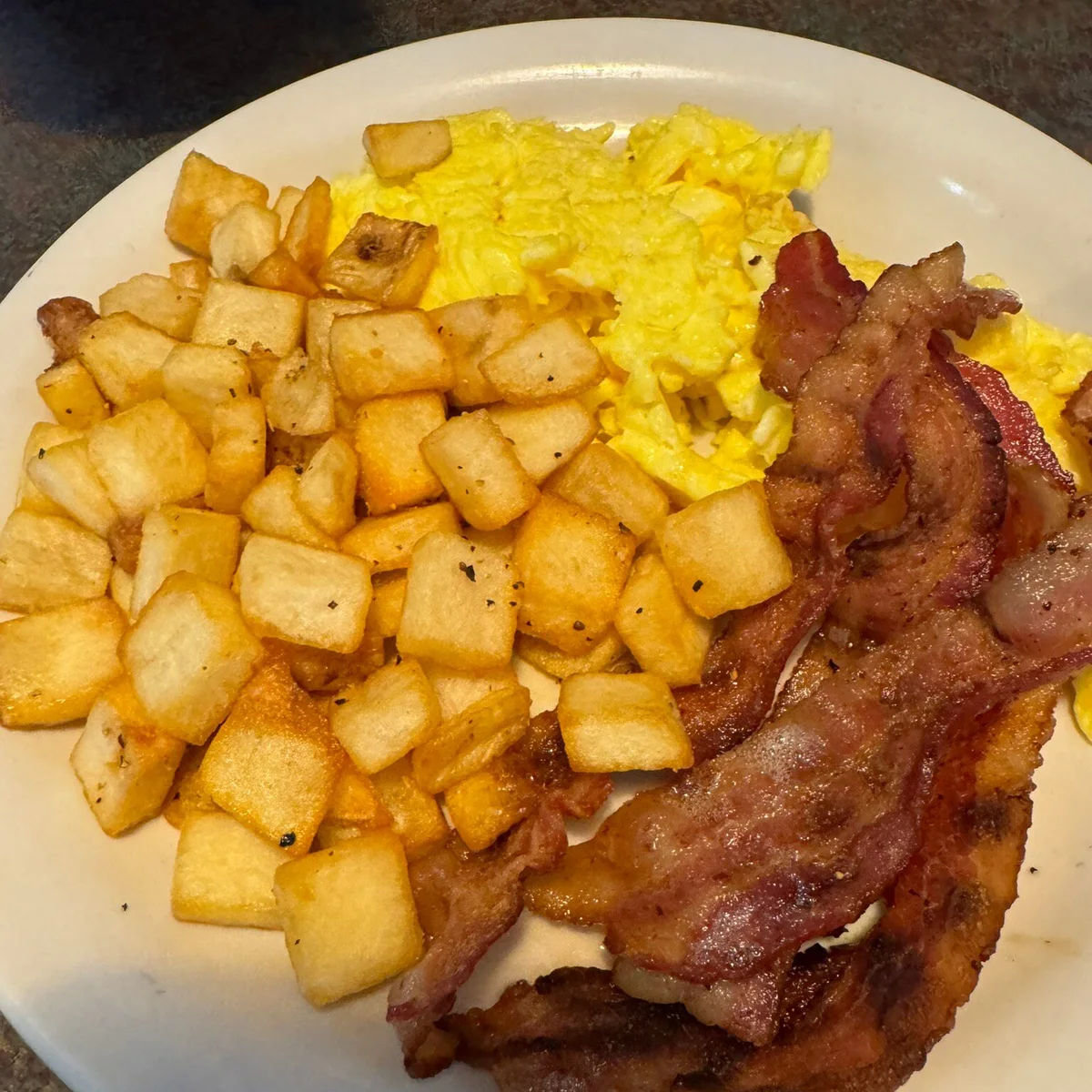 Guest photo of bacon, scrambled eggs, and home fries at Sharon’s Homestyle Cookin’