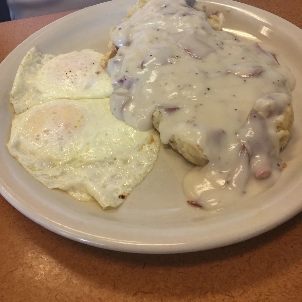 Guest photo of biscuits covered in country gravy at Sharon’s Homestyle Cookin’