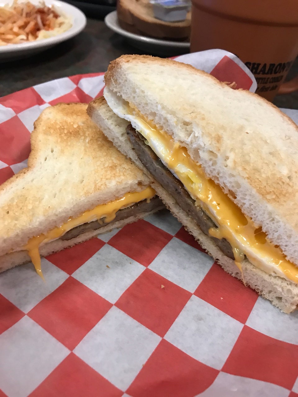 Guest photo of a grilled sandwich served on red-check paper